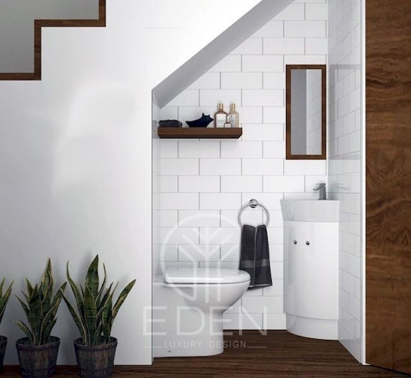 Nhà vệ sinh đơn giản với thiết kế màu trắng chủ đạo sang trọng nằm dưới gầm cầu thang